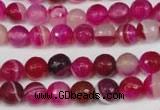 CAG2085 15.5 inches 6mm faceted round fuchsia line agate beads